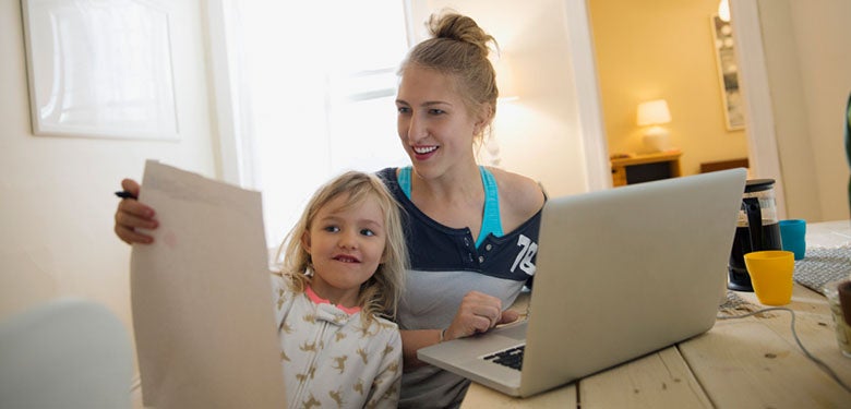 mom and daughter looking at their finances