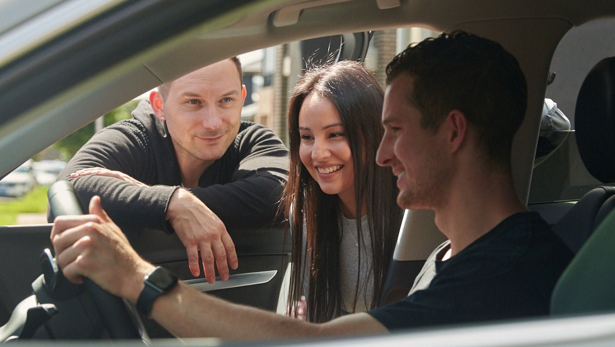 couple inspect a car