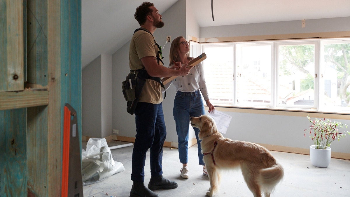 Lady checking a property interior together with a building inspector