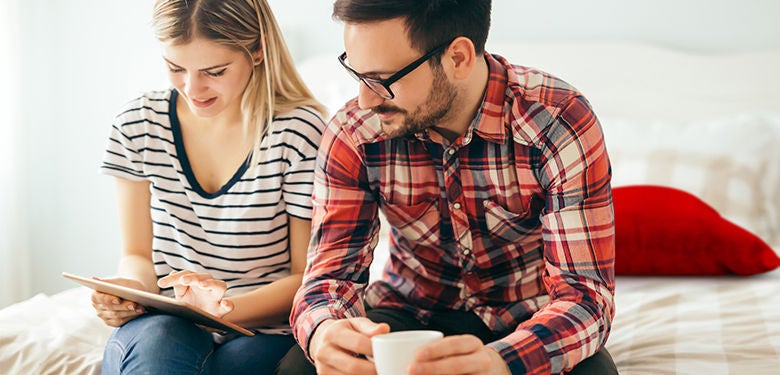 couple securing their online accounts to protect their identity couple securing their online accounts to protect their identity